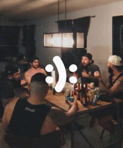 men around a table having candid conversation about mental health